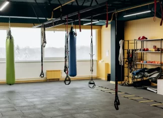 How does the shock absorbency of a surface affect an athlete’s performance and safety?